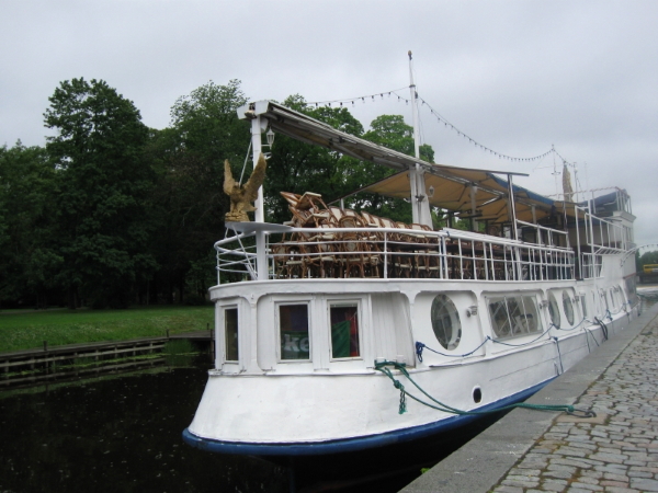 A dinner-cruise boat docked near the bridge, Islandsbro. King Carl Gustav